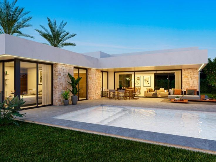 Parte exterior con la piscina en primer plano de la Vivienda Monforte al atardecer